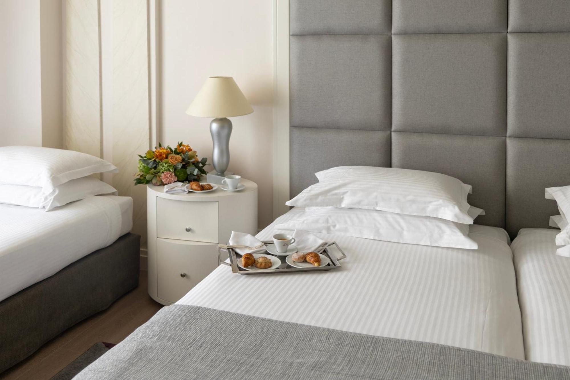 Njv Athens Plaza Hotel Exterior photo A bed with a nightstand